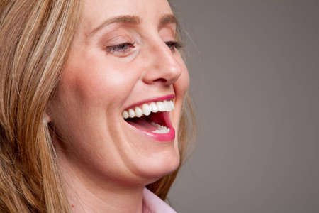 Close-up of the face of a happy, laughing womanの写真素材