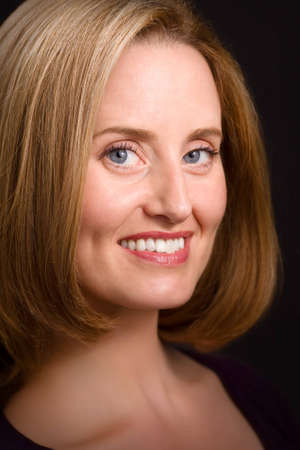 Glamorous blue-eyed woman smiling to cameraの写真素材