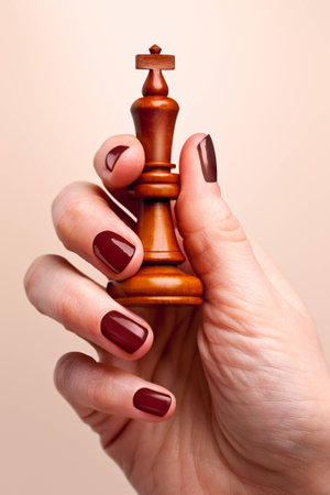 Chess king held in woman's handの写真素材