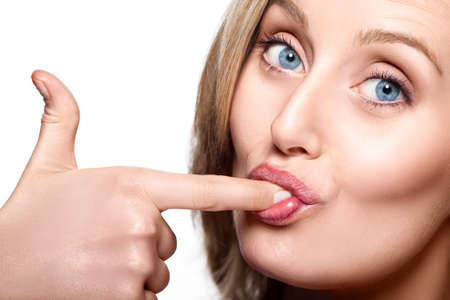 Close-up of caucasian woman licking her fingerの写真素材