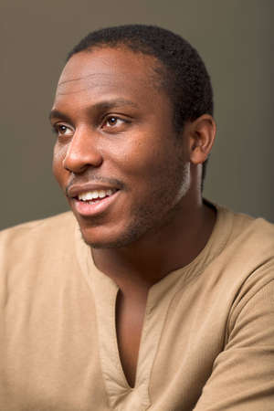 Colour studio portrait of a young African man in casual clothingの写真素材