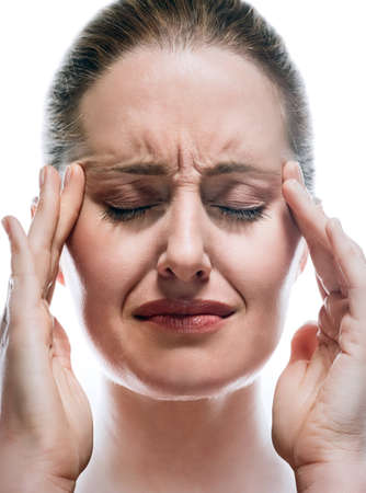 Telepath woman concentrating with hands on headの写真素材
