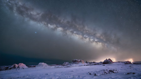 Night sky with stars and milky way over mountains. Long exposure
