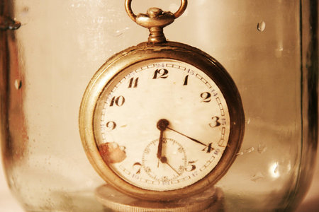 The old clock in a glass jarの写真素材