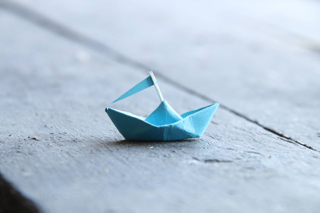 paper boat on old wooden table, travel ideaの写真素材