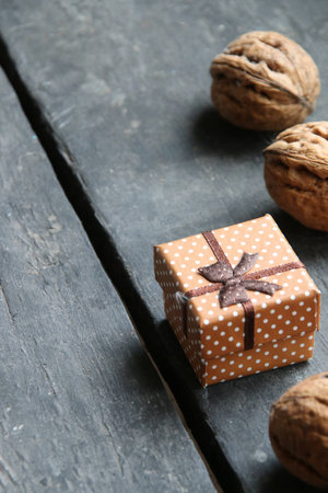 Walnuts and a gift on the tableの写真素材
