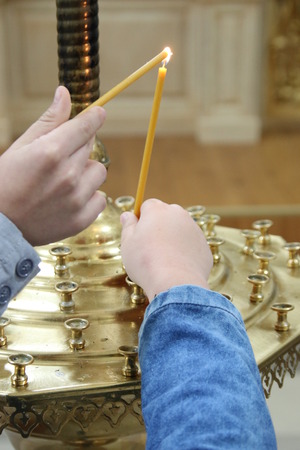 Burning candles in a churchの写真素材