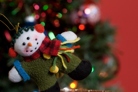 close up of a home made snowman ornament on a christmas tree.の写真素材