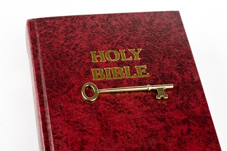 Bible with key against white backgroundの写真素材