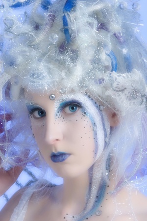 Woman with heavy stage makeup looking like a winter fairy.の写真素材