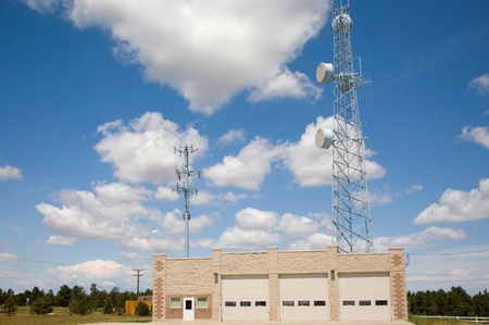 A volunteer fire station in rural Colorado.  Transmission towers high above building provide communications to other fire districts in emergencies.のeditorial素材