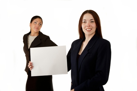 Woman with sign, other woman making face or gesture.の写真素材