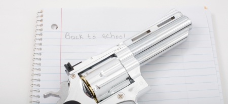 Handgun with school notebook paper の写真素材