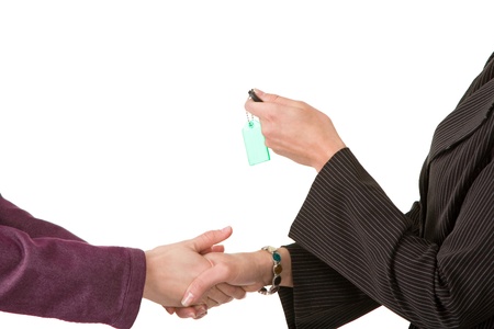 woman handing over house key to another woman.の写真素材