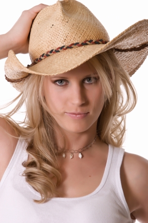Young cowgirl wearing cowboy hatの写真素材