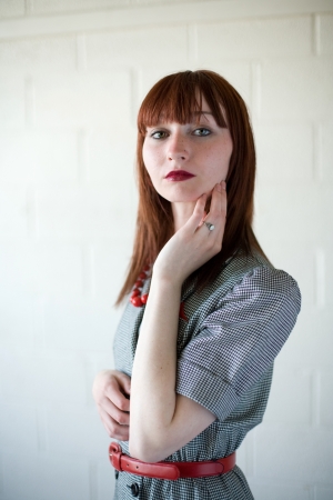 Young red haired woman wearing a retro styled suitの写真素材