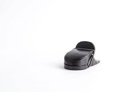 Mousetrap black in plastic and metal on a white background.