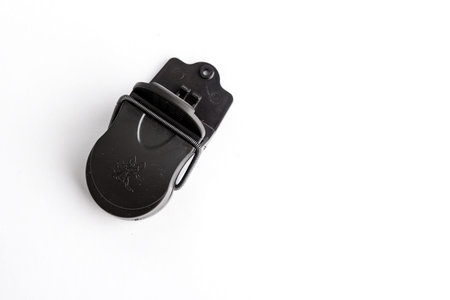 Mousetrap black in plastic and metal on a white background.