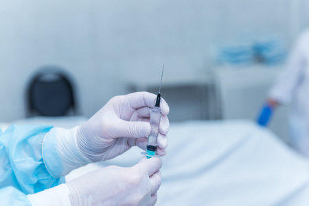 The hands of an anesthetist, who are taking medicine from the ampoule in a syringe. concept photo...