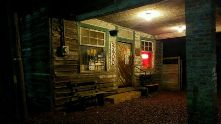Old wooden country tavern front at night.の素材