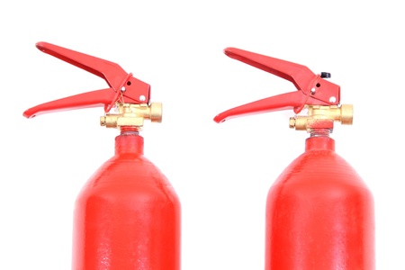 Two fire extinguishers on a white background.の写真素材