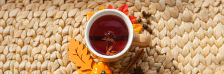 Karkade tea in an orange cup with autumn attributes. The concept of the autumn season, natural colors.の写真素材