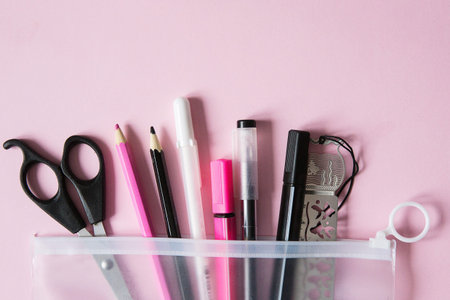 School supplies. Black, white and pink colors. Pink background. Back to school.