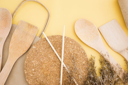 A set of eco-friendly bamboo Cutlery on yellow background. Concept of a waste-free lifestyle. Zero waste home.の写真素材