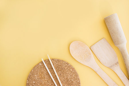 A set of eco-friendly bamboo Cutlery on yellow background. Concept of a waste-free lifestyle. Zero waste home.の写真素材