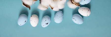 Easter background. Blue and white painted quail eggs on a blue backgroundの写真素材