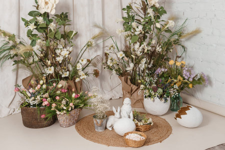 Interior floral Easter composition. Figurines of Easter bunnies and a large eggshell. The concept of...
