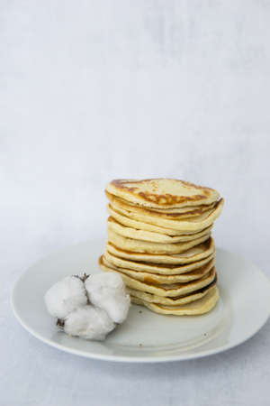 Homemade pancakes on kefir on a white plate. Cooking at home, home-cooked food. Space for text.の写真素材
