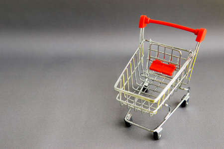 shopping cart on a gray background. Theme of purchases and sales. space for text.の写真素材