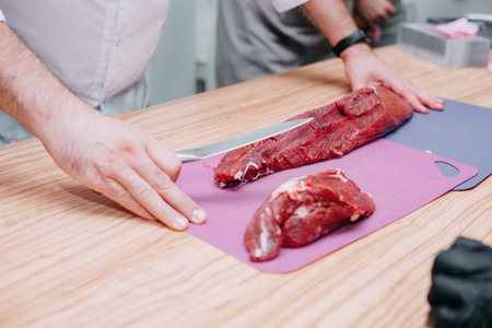 Preparation of raw meat roll. Cooking steaks and meat rolls in the cooking class. Sliced meat on a...