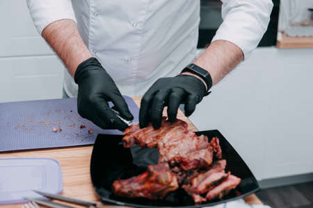 Cooking ribeye steaks and meat rolls in the cooking class. Sliced meat on a plate, close-up.の写真素材