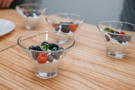 Dessert with wild berries: blackberries, blueberries, raspberries. Cream with berries at a cooking...