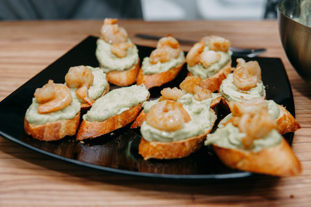 Bruschetta with fried prawns and Pesto sauce at a cooking class. Homemade food, cooking at home.