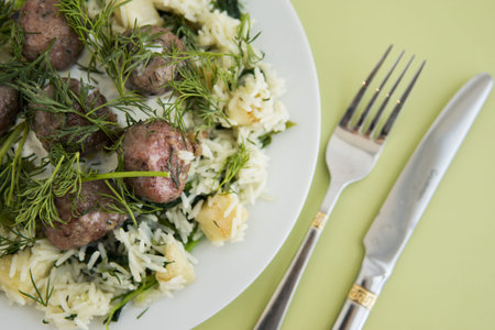 Swedish meatballs with dill, topped with celery and spinach rice. Cooking at home, home-cooked food.