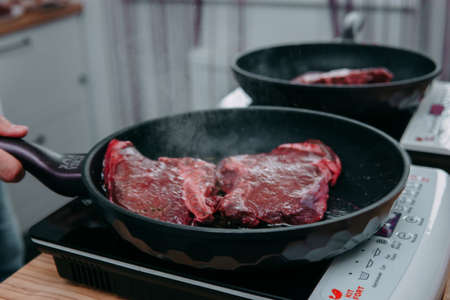 Raw beef meat for cooking steak. Raw beef is sliced, cooking meat for cooking steak in a cooking class.の写真素材