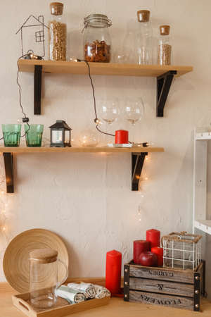 The kitchen is decorated in a Christmas style with red accents. Cozy atmosphere of winter holidaysの写真素材