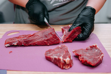 Preparation of raw meat roll. Cooking steaks and meat rolls in the cooking class. Sliced meat on a plate.の写真素材