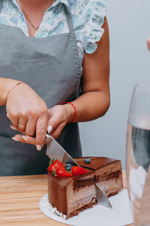A piece of chocolate cake in the cut. Preparation of mousse cake at a culinary master class. Cooking at home, homemade foodの写真素材