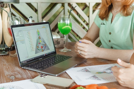 Tver, Russia-august 7, 2022. A woman with a laptop is studying human design. The concept of studying esoteric sciences. Studying rave postcards from human designのeditorial素材