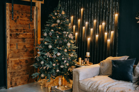 Christmas interior with a beautiful Christmas tree, sofa, light bulbs and dark background.のeditorial素材