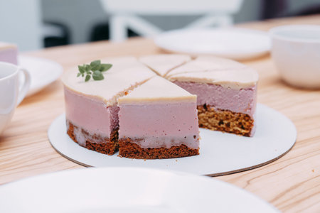 Sliced mousse cake on the table. Preparation of mousse cake at a culinary master class. Cooking at...