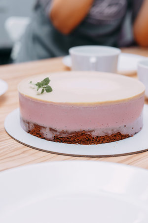 Sliced mousse cake on the table. Preparation of mousse cake at a culinary master class. Cooking at...