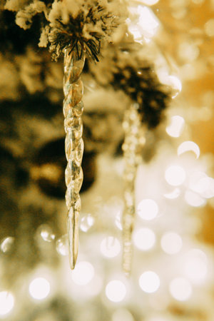 Icicles hanging on a Christmas tree close-up. A decor concept for decorating a house for the New...