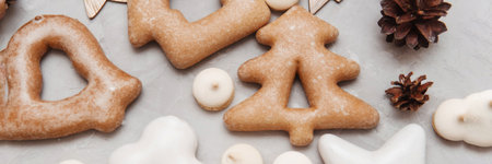 Banner for Christmas and New Year gingerbread stars, houses, Christmas trees, toys on a gray concrete background.の写真素材