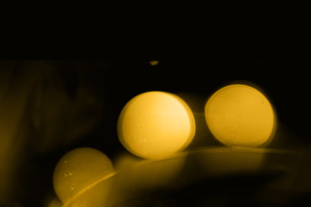 Blurry garland lights on a dark background. Festive Christmas and New Year background. Soft focusの写真素材