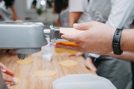 Cooking homemade pasta with your own hands. Cooking pasta at a cooking class. The process of leveling the dough for pasta.の写真素材